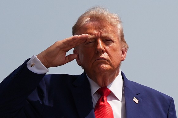 President Donald Trump salutes as a U.S. Army carry team moves a transfer case containing the remains of Pvt. Isabella Gonzales of Carrollton, Texas, Wednesday, July 22, 2026, at Dover Air Force Base, ...