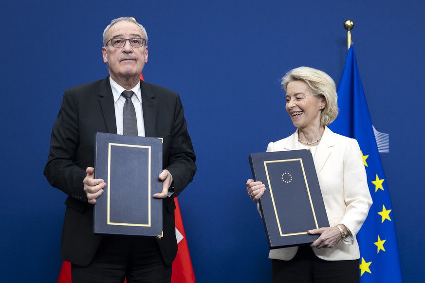 Swiss Federal President Guy Parmelin, left, and European Commission President Ursula von der Leyen react after signing a package of bilateral agreements between the European Union and Switzerland, in  ...