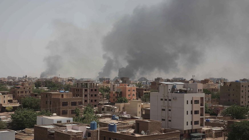 Smoke rises from a central neighborhood of Khartoum, Sudan, Sunday, April 16, 2023, after dozens have been killed in two days of intense fighting. The Sudanese military and a powerful paramilitary gro ...