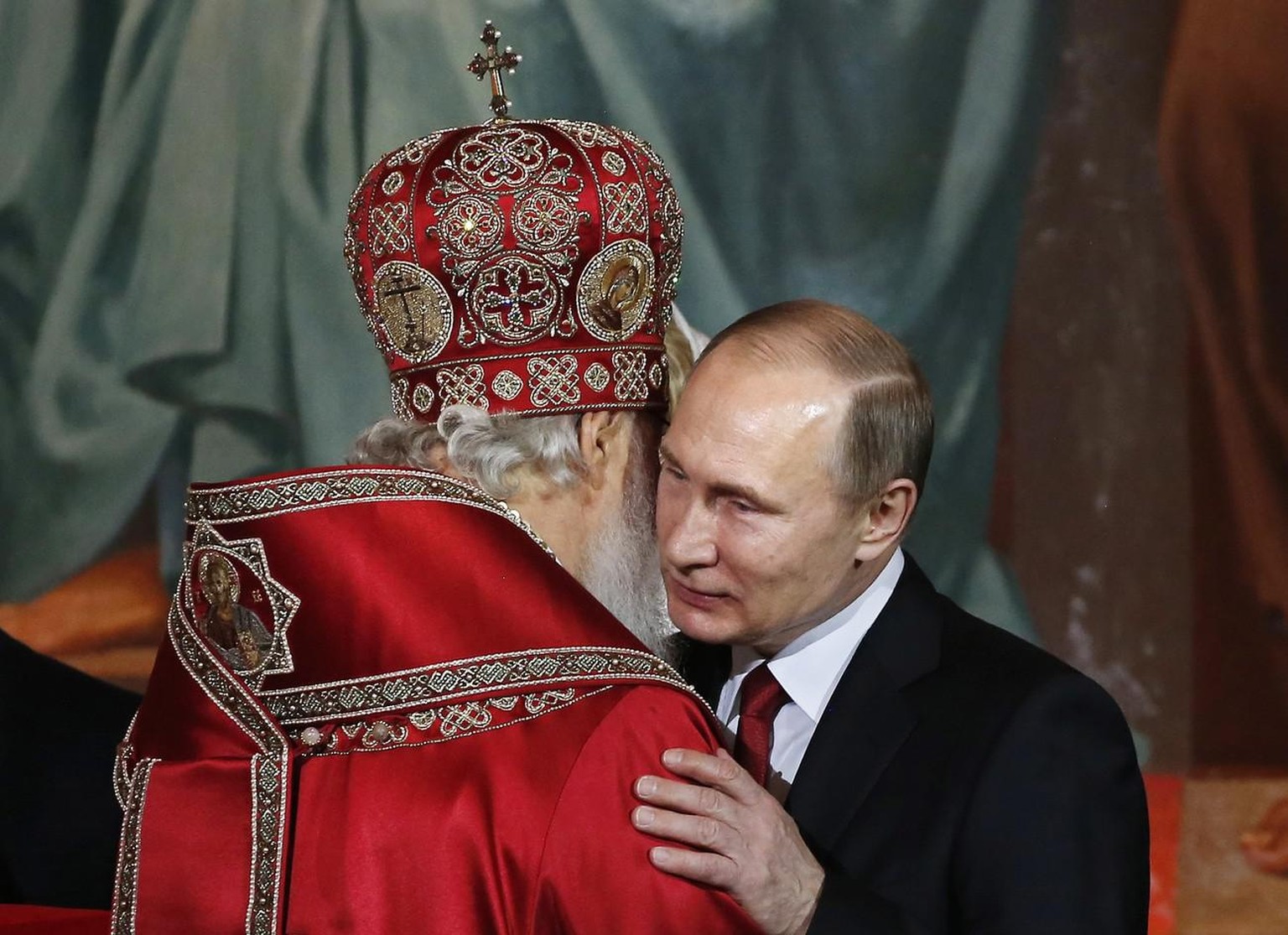 Patriarch of Moscow and All Russia Kirill (L) kisses Russian President Vladimir Putin (R) as they congratulate each other during the Orthodox Easter holiday service in Moscow&#039;s Christ the Savior  ...