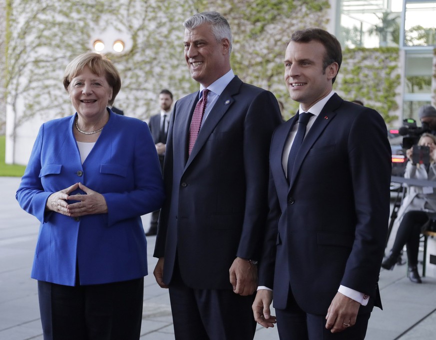 German Chancellor Angela Merkel, President of France Emmanuel Macron, right, welcome Kosovo president Hashim Thaci for a meeting of Balkan leaders at the chancellery in Berlin, Monday, April 29, 2019. ...