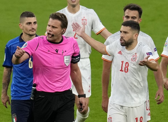 Spain&#039;s Jordi Alba, right, gestures to referee Felix Brych as they leave the field for the halftime break during the Euro 2020 soccer championship semifinal between Italy and Spain at Wembley sta ...