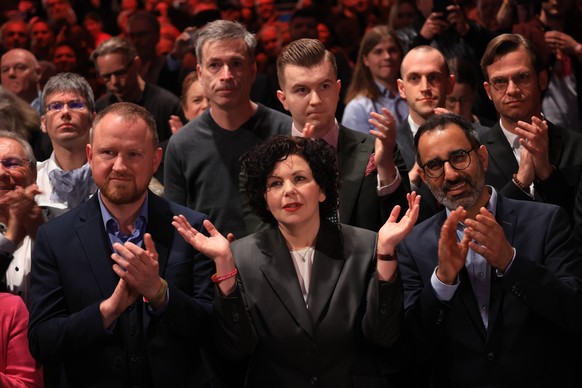 epa11918940 BSW party co-chairwoman Amira Mohamed Ali (C) and Secretary General Christian Leye (L) await the speech of top candidate Sahra Wagenknecht during the Alliance (BSW) election event in Berli ...