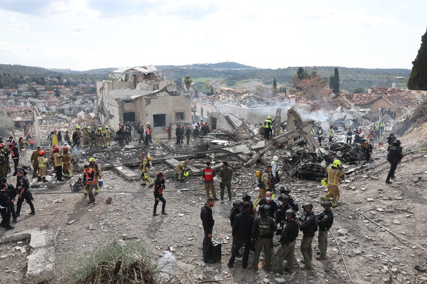 epa12787358 Rescue forces work among debris following an Iranian rocket attack that hit Beit Shemesh near Jerusalem, Israel, 01 March 2026. Israeli police confirmed at least nine fatalities as a resul ...
