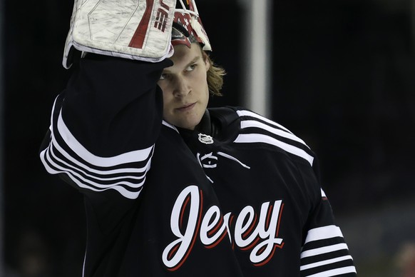 New Jersey Devils goaltender Akira Schmid reacts during the first period of an NHL hockey game against the Dallas Stars Tuesday, Jan. 25, 2022, in Newark, N.J. (AP Photo/Adam Hunger)
Akira Schmid