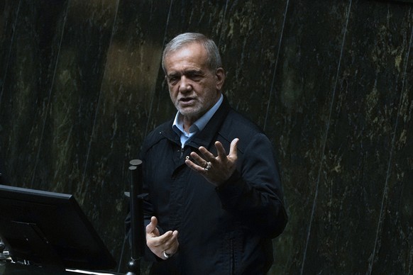 Iranian President Masoud Pezeshkian speaks in an open session of parliament to debate on his next year's budget bill, in Tehran, Iran, Tuesday, Oct. 29, 2024. (AP Photo/Vahid Salemi)