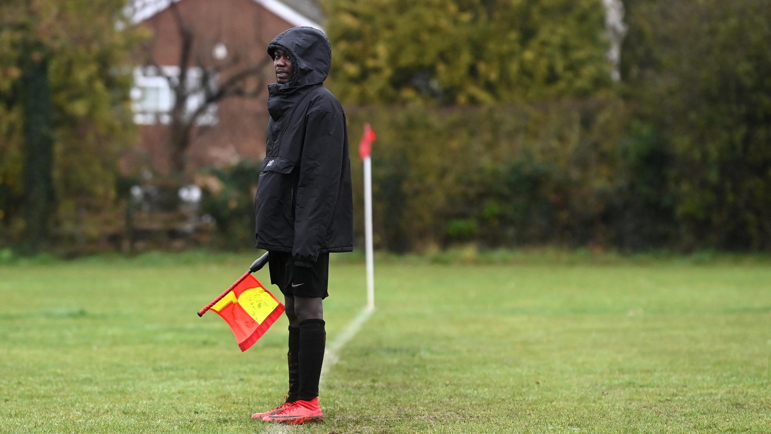epa09060958 (24/25) Sanctuary Strikers Football Club player Adam Hussai acts as a lines-man as his team play against Goring United in Goring-On-Thames, Britain, 13 December 2020 (issued 08 March 2021) ...