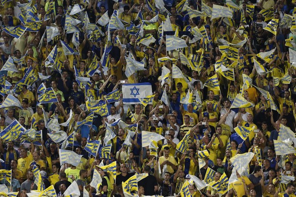 epa04898021 Maccabi Tel Aviv supporters cheer on their team during the UEFA Champions League play-off round second leg soccer match between Maccabi Tel Aviv FC and FC Basel 1893 at the Bloomfield stad ...