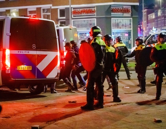 epa08965312 Police on the Beijerlandselaan during clashes with a group of young people in Rotterdam, The Netherlands, 25 January 2021. Police&#039;s mobile unit is present and has carried out charges  ...