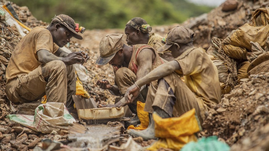 Gold miners pan for gold in the Eastern Congo mining town of Kamituga March 13 2021. The U.S. announced sanctions Thursday March 17 2022 targeting Alain Goetz and African Gold Refinery, a Uganda-based ...