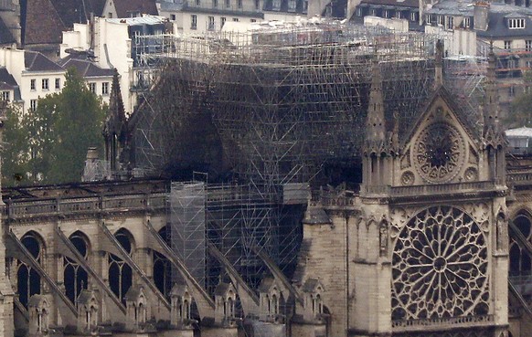 Notre Dame cathedral is pictured from the top of the Montparnasse tower, Tuesday April 16, 2019 in Paris. Firefighters declared success Tuesday morning in an over 12-hour battle to extinguish an infer ...