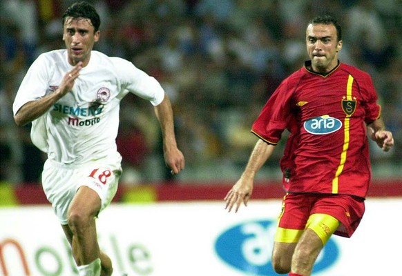 Antzas of Olympiakos Piraeus, left, and Galatasaray&#039;s Arif Erdem challenge for the ball at Ataturk Olympic stadium in Istanbul, Turkey, Wednesday July 31, 2002, during a friendly soccer game betw ...