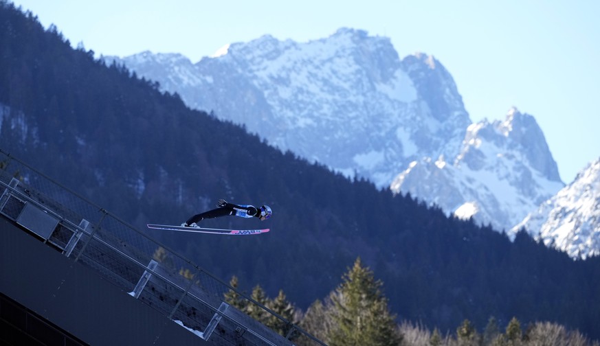 Ryoyu Kobayashi, of Japan, soars through the air, with the Zugspitze, Germany&#039;s highest peak, in the background, during training at the second stage of the 73rd Four Hills ski jumping tournament  ...