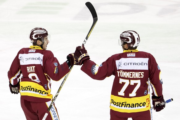 Geneve-Servette&#039;s forward Damien Riat, left, celebrates his goal with teammates defender Henrik Toemmernes, of Sweden, right, after scored the 1:0, during a National League regular season game of ...