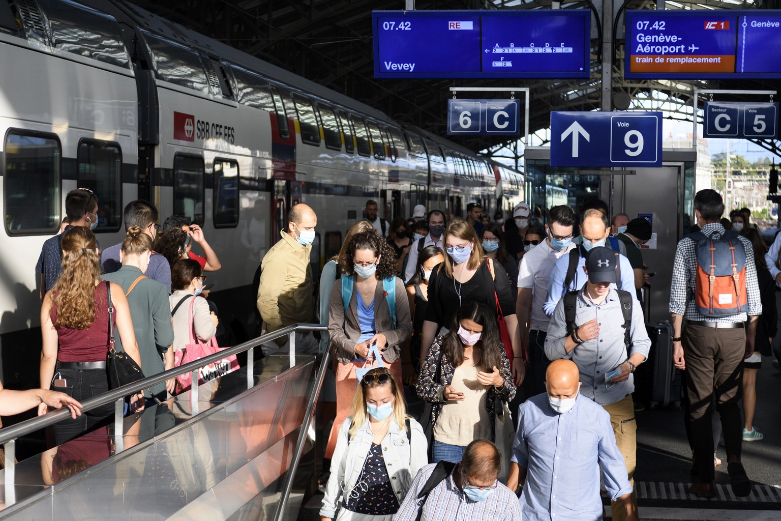 People wearing protective mask get out a SBB CFF train during the coronavirus disease (COVID-19) outbreak, at the train station CFF in Lausanne, Switzerland, Monday, July 6, 2020. In Switzerland, from ...