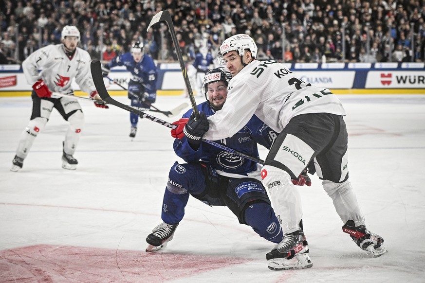 Ambri&#039;s Dominic Zwerger, left, and Pardubice&#039;s Jan Kolar, right, challenge for the cup during the game between Switzerland&#039;s HC Ambri-Piotta and the Czech HC Republic&#039;s Dynamo Pard ...