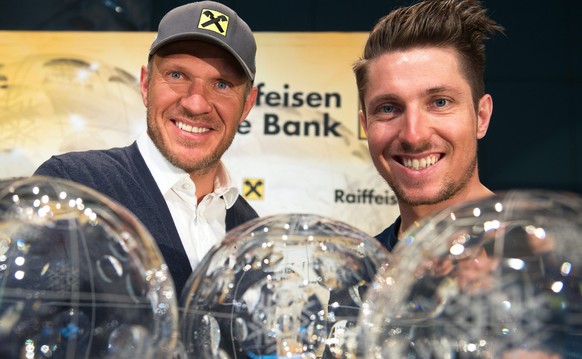 epa05227023 Austrian skier Marcel Hirscher (R) and former Austrian skier Hermann Maier (L) pose next to Hirscher's five overall FIS Alpine Skiing World Cup trophies during a press conference in V ...