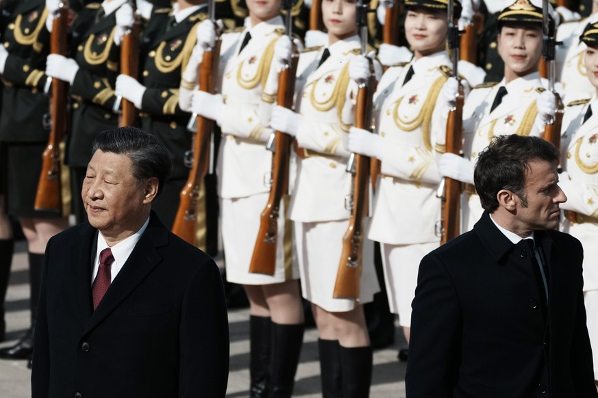 FILE - Chinese President Xi Jinping, left, and France&#039;s President Emmanuel Macron review troops during a welcome ceremony at the Great Hall of the People in Beijing, China, April 6, 2023. Russian ...
