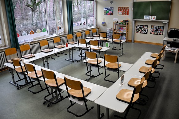 epa08947397 Chairs are placed on tables in a classroom at the closed elementary school ?Am Weyer? in Dinslaken, Germany, 18 January 2021. To slow the spread of the coronavirus, schools in Germany remain closed. All students must study from home during the nationwide lockdown. The heads of the German states will meet with German Chancellor Angela Merkel on 19 January 2021, to discuss how to proceed in the corona crisis. The current lockdown is to be extended beyond 31 January 2021. A complete shutdown in Germany and an actual curfew are also being discussed.  EPA/SASCHA STEINBACH