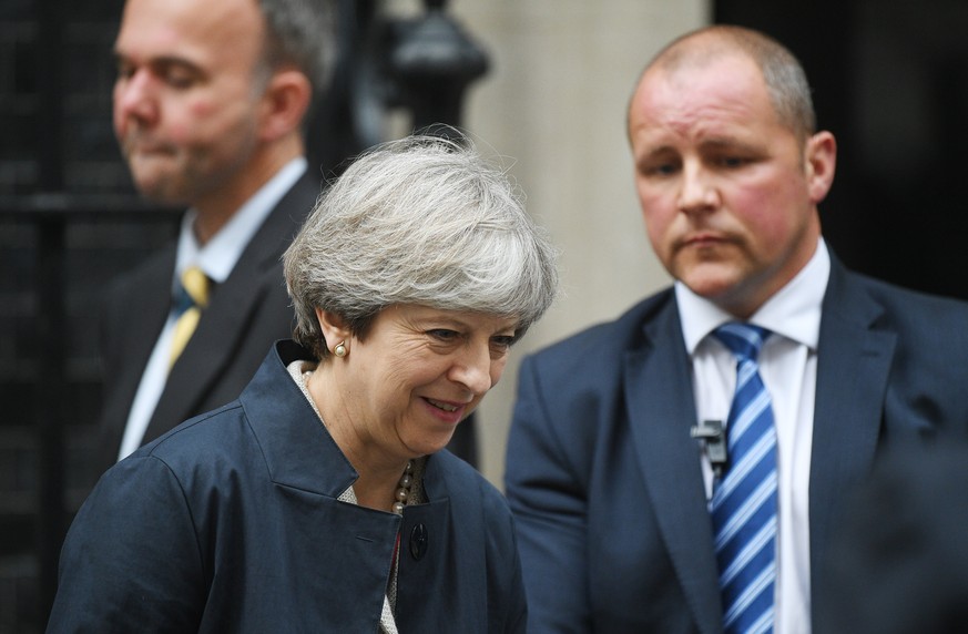 epa06056215 British Prime Minister Theresa May (L) leaves 10 Downing street to attend a vote in the Houses of Parliament in London, Britain, 29 June 2017. The Prime Minister arrived from Germany as he ...