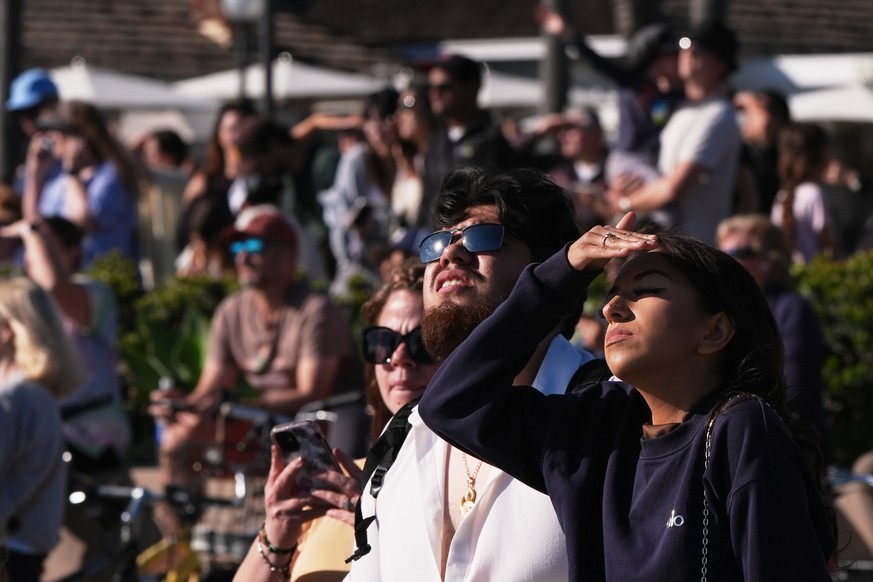 People wait for a glimpse of the return of NASA's Artemis II Friday, April 10, 2026, along the beach in Coronado, Calif. (AP Photo/Gregory Bull)
NASA Artemis Moonshot