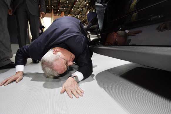 epa06710197 (FILE) - Former CEO of German car manufacturer Volkswagen (VW), Martin Winterkorn checks the bottom side of a Porsche GT2 during a tour on the first media day of the 78th Geneva Internatio ...