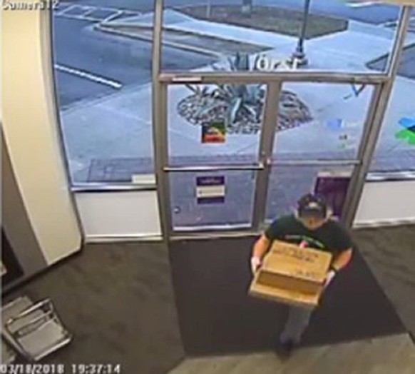 A surveillance image shows the serial bombing suspect entering a FedEx office store in Austin, Texas, U.S., which was given to law enforcement and obtained by TV station, WOAI/KABB, March 21, 2018. Co ...