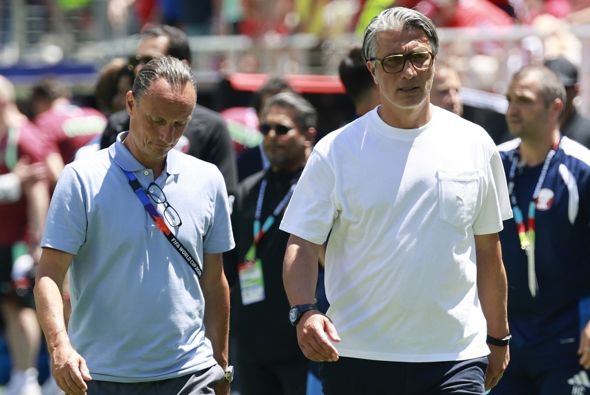 Switzerland's head coach Murat Yakin, right, and Adrian Arnold, chief communication, leave the pitch after the World Cup Group B soccer match between Qatar and Switzerland at the San Francisco Ba ...