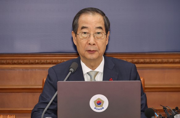 epa11776307 South Korean Prime Minister Han Duck-soo, serving as the acting president following the passage of an impeachment motion against President Yoon Suk Yeol at the National Assembly, convenes  ...