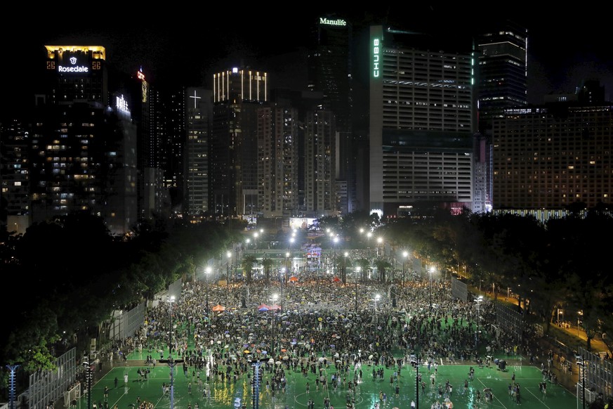 Protesters attend a rally at Victoria Park in Hong Kong, Sunday, Aug. 18, 2019. Heavy rain fell on tens of thousands of umbrella-toting protesters Sunday as they marched from a packed park and filled  ...