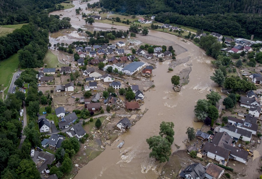 The Ahr river floats past destroyed houses in Insul, Germany, Thursday, July 15, 2021. Due to heavy rain falls the Ahr river dramatically went over the banks the evening before. (AP Photo/Michael Prob ...