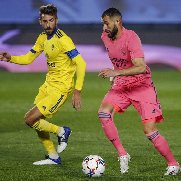 ESP: Real Madrid-Cadiz CF. La Liga Santander. Karim Benzema of Real Madrid and Jose Mari Martin of Cadiz CF during the La Liga match between Real Madrid and Cadiz CF played at Alfredo Di Stefano Stadi ...