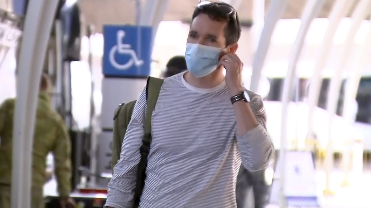 In this image made from a video, Australian Broadcasting Corp. journalist Bill Birtles arrives at Sydney airport, Australia Tuesday, Sept. 8, 2020. Birtles and The Australian Financial Review journali ...