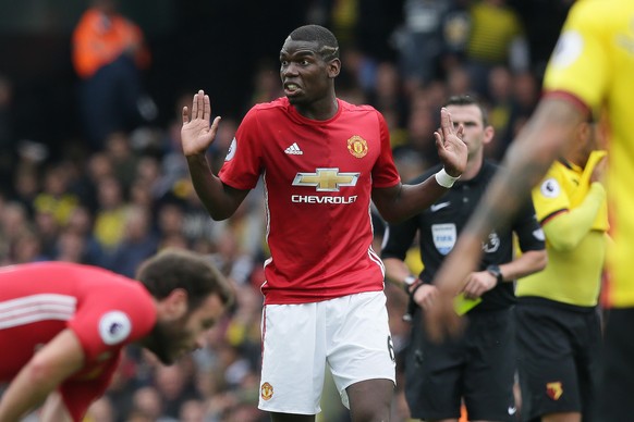 Manchester United&#039;s Paul Pogba holds up his hands and looks to the bench during the English Premier League soccer match between Watford and Manchester United at Vicarage Road in London, Sunday Se ...