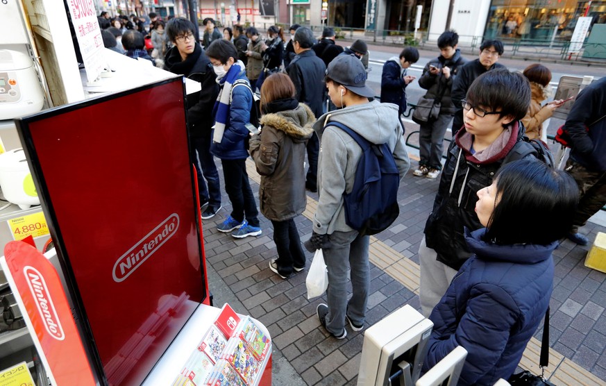 People line up to get their hands on the Nintendo Switch game console outside an electronics store in Tokyo, Japan March 3, 2017. REUTERS/Toru Hanai