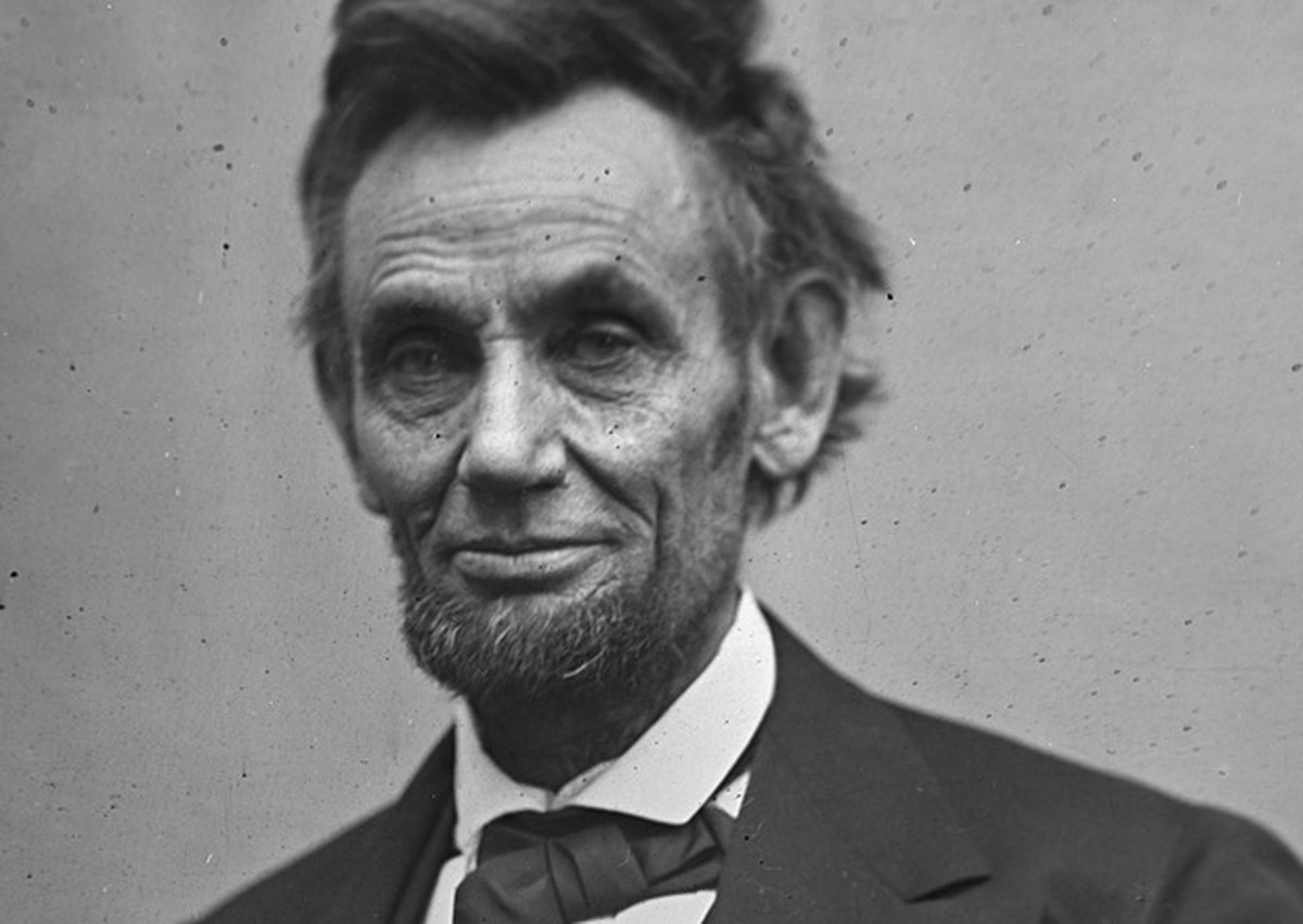 In this photo provided by the Library of Congress, Abraham Lincoln is pictured in a three-quarter length portrait, seated and holding his spectacles and a pencil. This image was taken by photographer ...