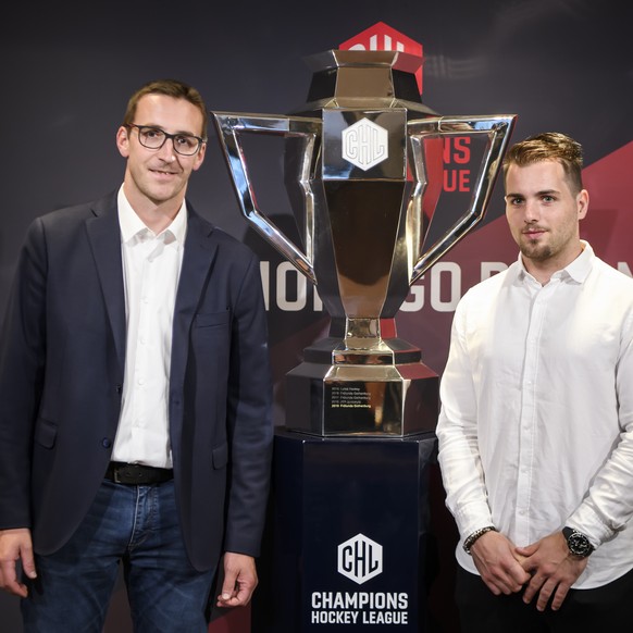 HC Ambri-Piotta Head Coach Luca Cereda, left, and HC Ambri-Piotta Player Marco Mueller, right, take a pose next to the CHL Cup during a press conference about the current developments of the Champions ...
