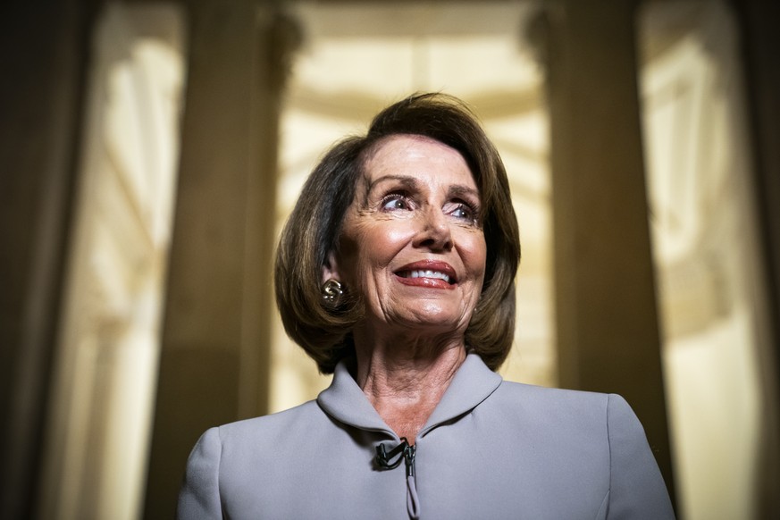 epa07258757 Democratic House Minority Leader and likely next Speaker of the House from California Nancy Pelosi speaks with the media while walking through the US Capitol prior to meeting with US Presi ...