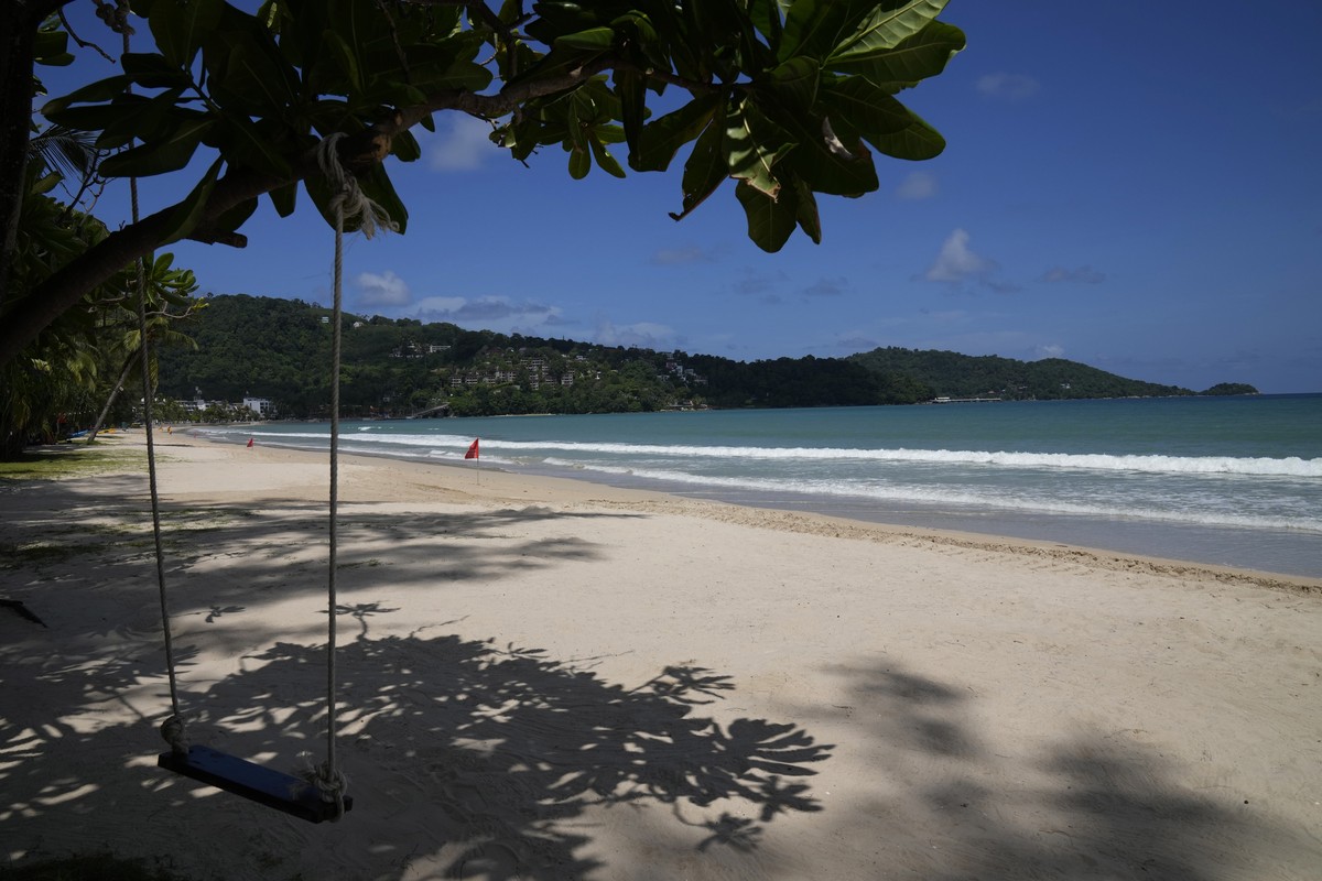 An empty swing hangs from a tree on the empty tourist beach of Patong on Phuket, southern Thailand, Monday, June 28, 2021. Thailand's government will begin the "Phuket Sandbox" scheme t ...