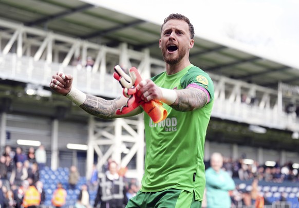 Brentford goalkeeper Mark Flekken celebrates following the English Premier League soccer match between Brentford FC and Luton Town at Kenilworth Road stadium, in Luton, England, Saturday April 20, 202 ...