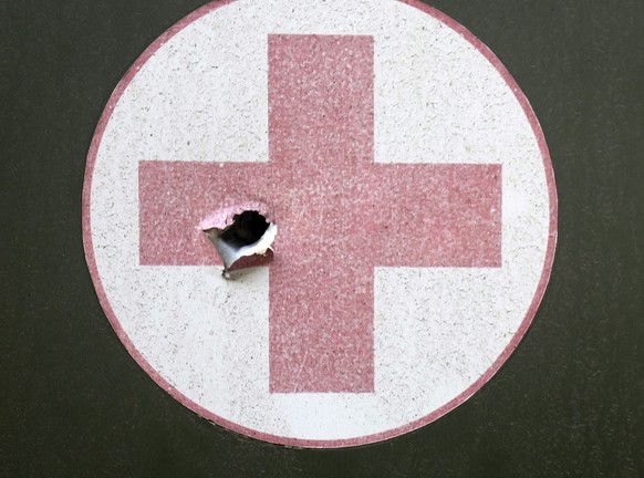 epa10001992 A Red Cross sign on a medical car with a bullet hole in Donetsk area, Ukraine, 08 June 2022. Russian troops on 24 February entered Ukrainian territory, starting a conflict that has provoke ...