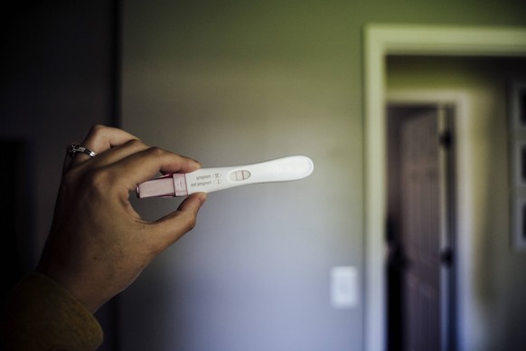 Positive Pregnancy Test Held by Woman s Hand Saint Paul, Minnesota, United States CR_MZGL230217-1128351-01