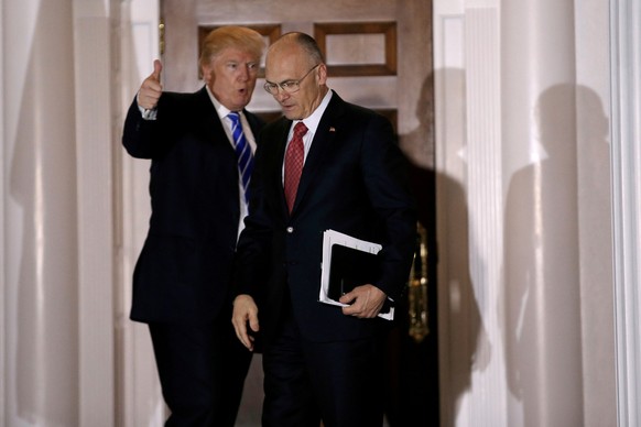 FILE PHOTO - U.S. President-elect Donald Trump gestures as Andy Puzder, CEO of CKE Restaurants, departs after their meeting at the main clubhouse at Trump National Golf Club in Bedminster, New Jersey, ...