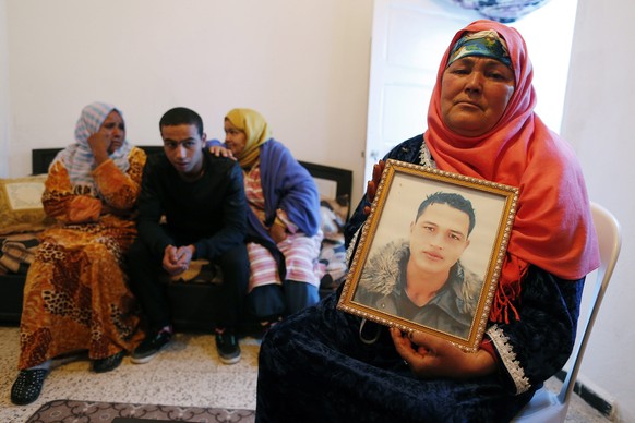 epa05685591 Nour Al Houda (R), 65, poses with a portrait of her son Anis Amri who is subject of an European arrest warrant in relation with the 19 December truck attack on a Christmas market in Berlin ...
