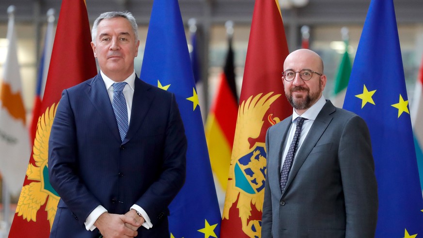 epa09775405 President of Montenegro Milo Dukanovic (L) is welcomed by European Council President Charles Michel (R) ahead of their meeting at the European Council in Brussels, Belgium, 21 February 202 ...