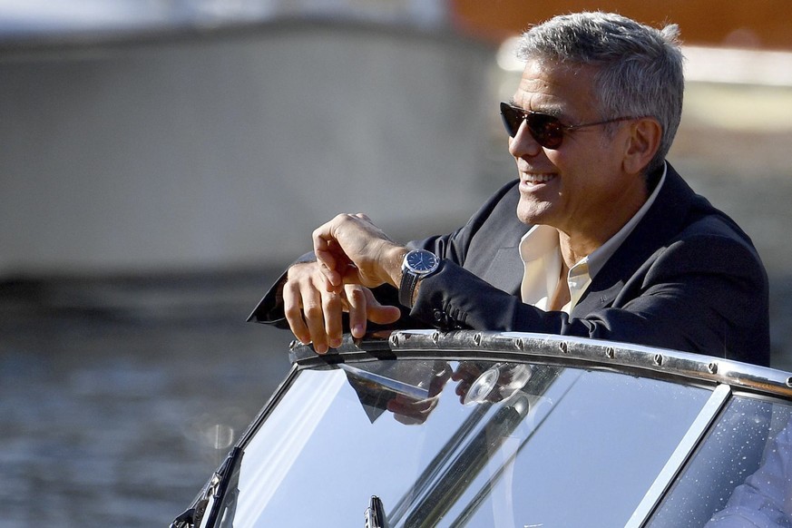 Actor George Clooney poses for photographers as he leaves on a boat during the 74th edition of the Venice Film Festival, in Venice, Italy, Friday, Sept. 1, 2017. (Ettore Ferrari/ANSA via AP)