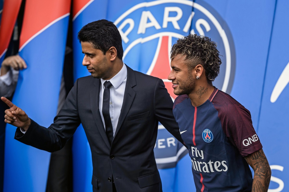 epa06124323 Paris Saint Germain's chairman and CEO Nasser Al-Khelaif (L) and Brazilian striker Neymar Jr (R) pose for photographs with his new PSG jersey after a press conference at the Parc des  ...