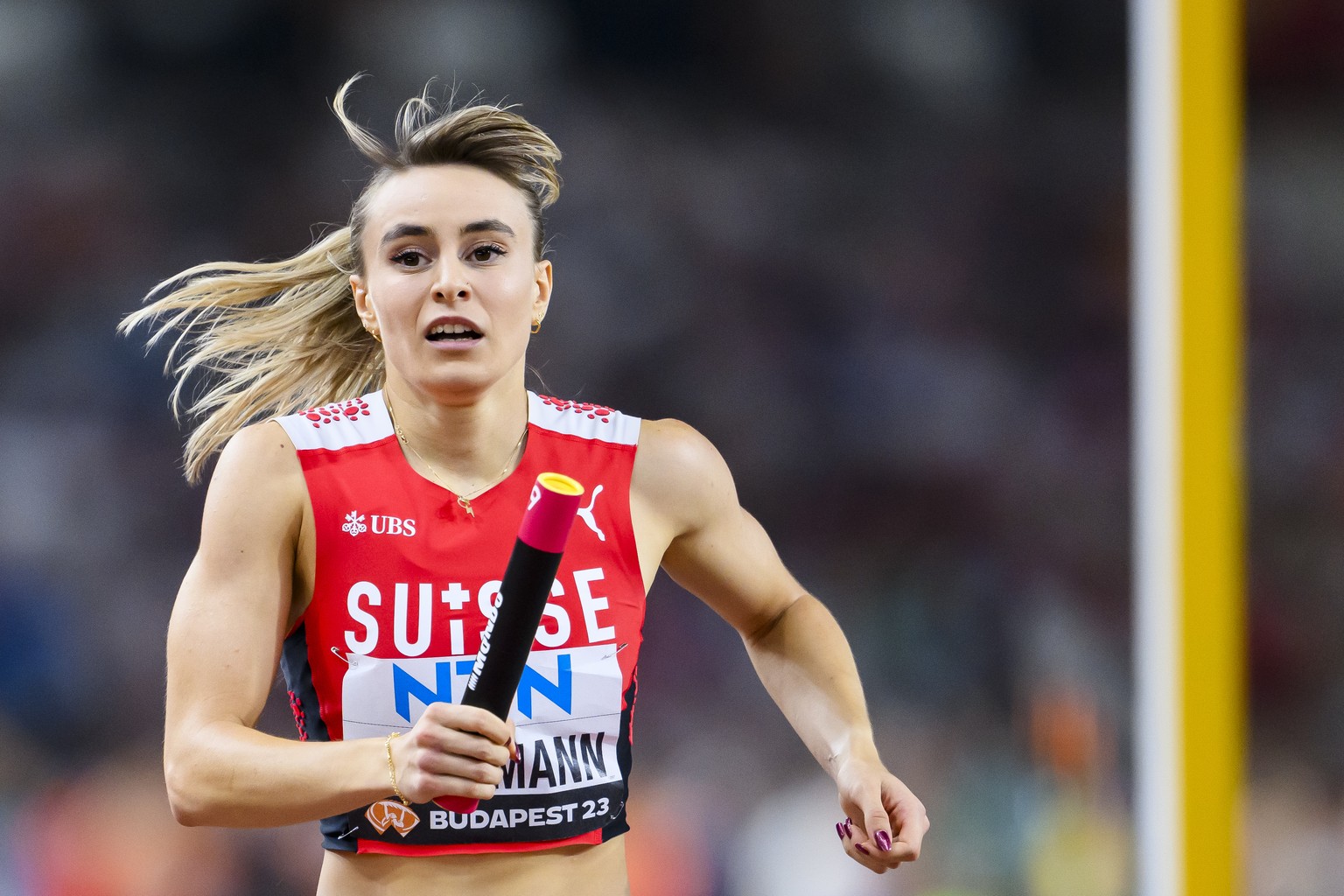 Catia Gubelmann of Switzerland reacts during the women&#039;s 4x400 meters relay qualification of the World Athletics Championships at the National Athletics Centre, in Budapest, Hungary, Saturday, Au ...