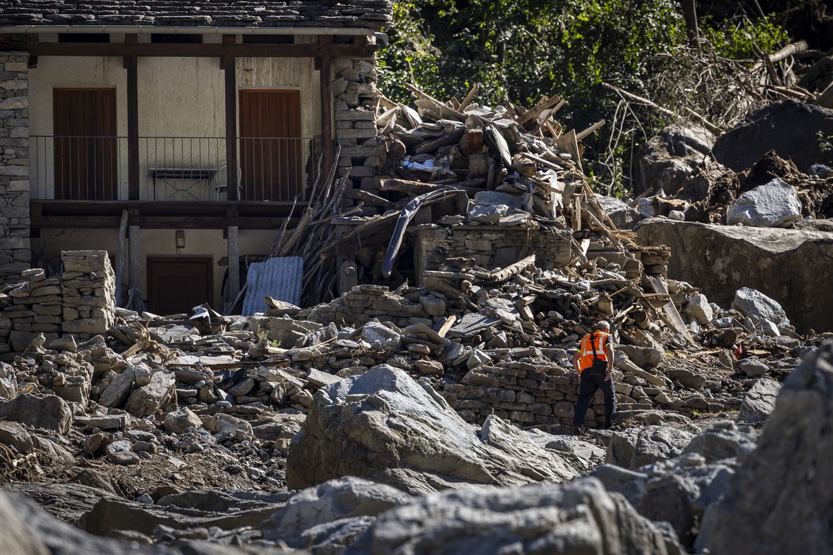 A man inspects a destroyed house in a massive landslide in Fontana, in Val Bavona in the Maggia Valley, southern Switzerland on Thursday July 4, 2024. Severe storms and torrential rain over the last w ...