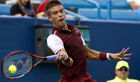 epa04888377 Borna Coric of Croatia hits a return shot to Alexander Zverev of Germany during their first round match at the Western &amp; Southern Open at the Linder Family Tennis Center in Mason, near ...